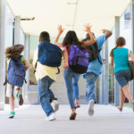 Elementary school pupils running outside