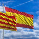 Catalonia and Spain flags waving on blue sky background. 3d illustration